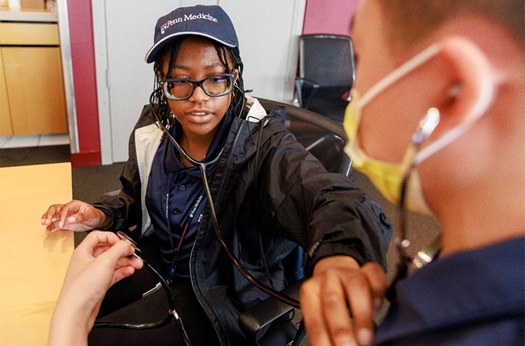 Student checking heart rate in class